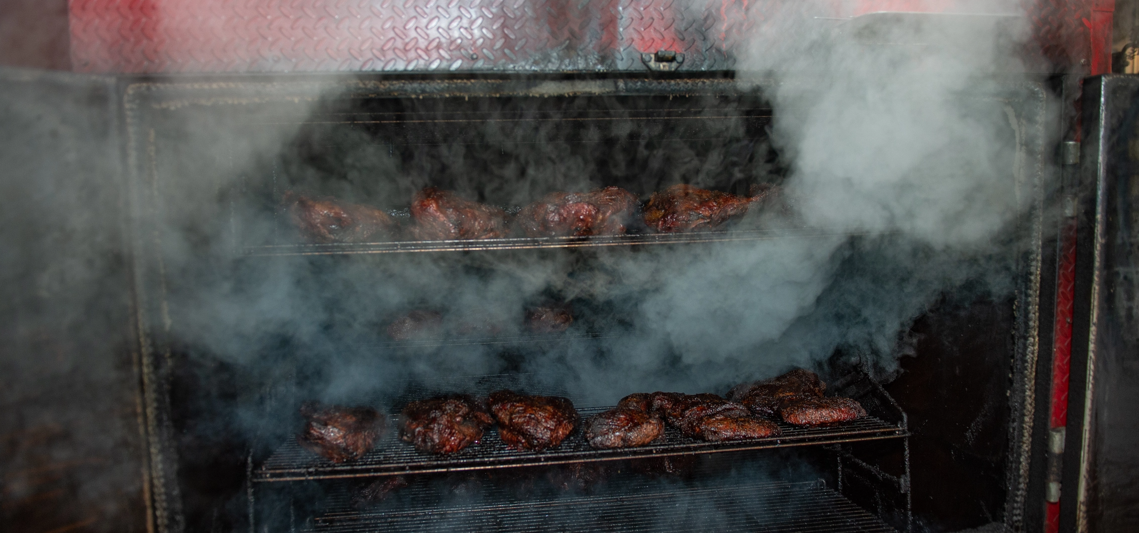 Smoke pouring out of a grill